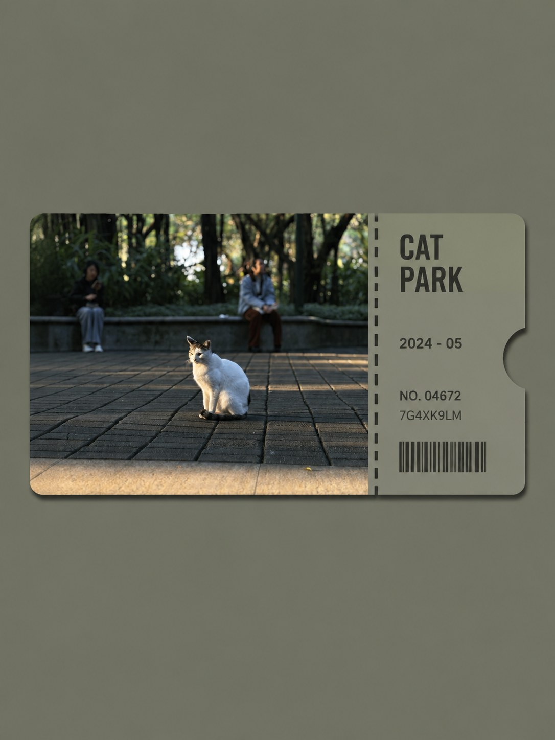A ticket stub of a cat in a park, the tab reading CAT PARK — a photo turned into art in the Photo ticket card style
